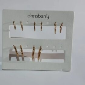 Gold hoop earring collection on black display stand