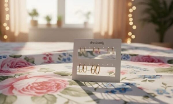 Gold hoop earring collection on black display stand